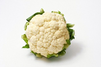 White cauliflower with green leaves 
